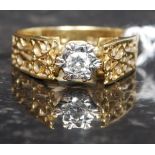 An 18t gold and diamond ladies gypsy ring having a fret worked shank with inset diamond approx