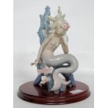 A vintage Lladro Ocean Beauty figurine raised on a mahogany plinth base.