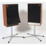 A pair of retro Mordant Short Festival 2 speakers raised on a pair of quadrabased chrome floor