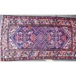 A good Persian Islamic rug having central large medallion design with beige geometric pattern