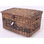 A vintage early 20th century whicker hamper / basket having animal hide straps  with notation to