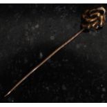 A 19th century 9ct gold Victorian hat pin. The pin with a scrolled knot.