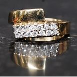 A 9ct gold hallmarked dress ring set with clear stones in an overlapping twin band. Weight 3.3g.