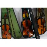 A group of three cased Violins to include two Chinese and another,