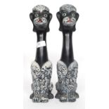 A pair of mid-20th century kitsch long necked ceramic figures of dogs.