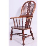 A Victorian yew wood and elm country windsor armchair.