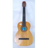 A Spanish six string acoustic guitar with three music books of which two are for folk music