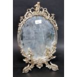 A decorative white metal barbola mirror dating to the mid 20th century.