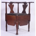 A 19th century Georgian mahogany corner chair commode.