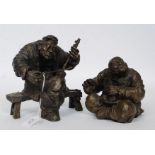 A pair of heavy cast vagabond bronze fig