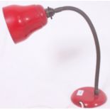 A vintage red gooseneck anglepoise style