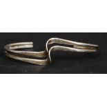 A ladies silver 925 split stem bracelet of swirl contemporary form.