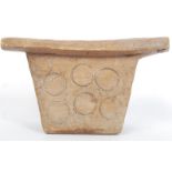 An East African Tribal stool raised on double supports carved with circular motifs.