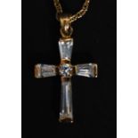 A 9ct gold crucifix pendant necklace and chain. The crucifix inset with CZ baguette stones.