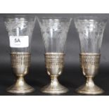 A run of 3 cut glass and silver stirrup cups. Marked Sterling 8186 with laurel wreath.