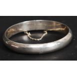 A traditional silver bracelet of hoop form with safety clasp. Stamped 925.
