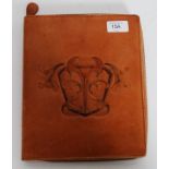 An Art Nouveau leather embossed personal organiser with sectional interior marked to the inside