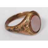 A Victorian 9ct gold agate stone ring, The oval stone set in decorative mount. Weight 2.