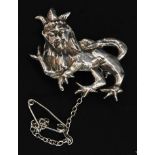 A silver brooch in the form of a passant crowned lion with pin to verso. Total weight 7.