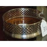 A modern .925 silver circular pierced wine coaster with wooden base, 13cm diameter, 4.5cm high.