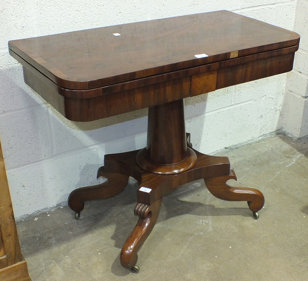 A 19th century mahogany fold-over tea table on turned column and quadruped base, 91.5cm wide.