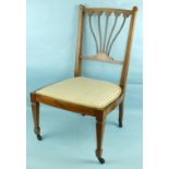 A pair of Edwardian rosewood low nursing chairs, each with pierced and inlaid back and upholstered