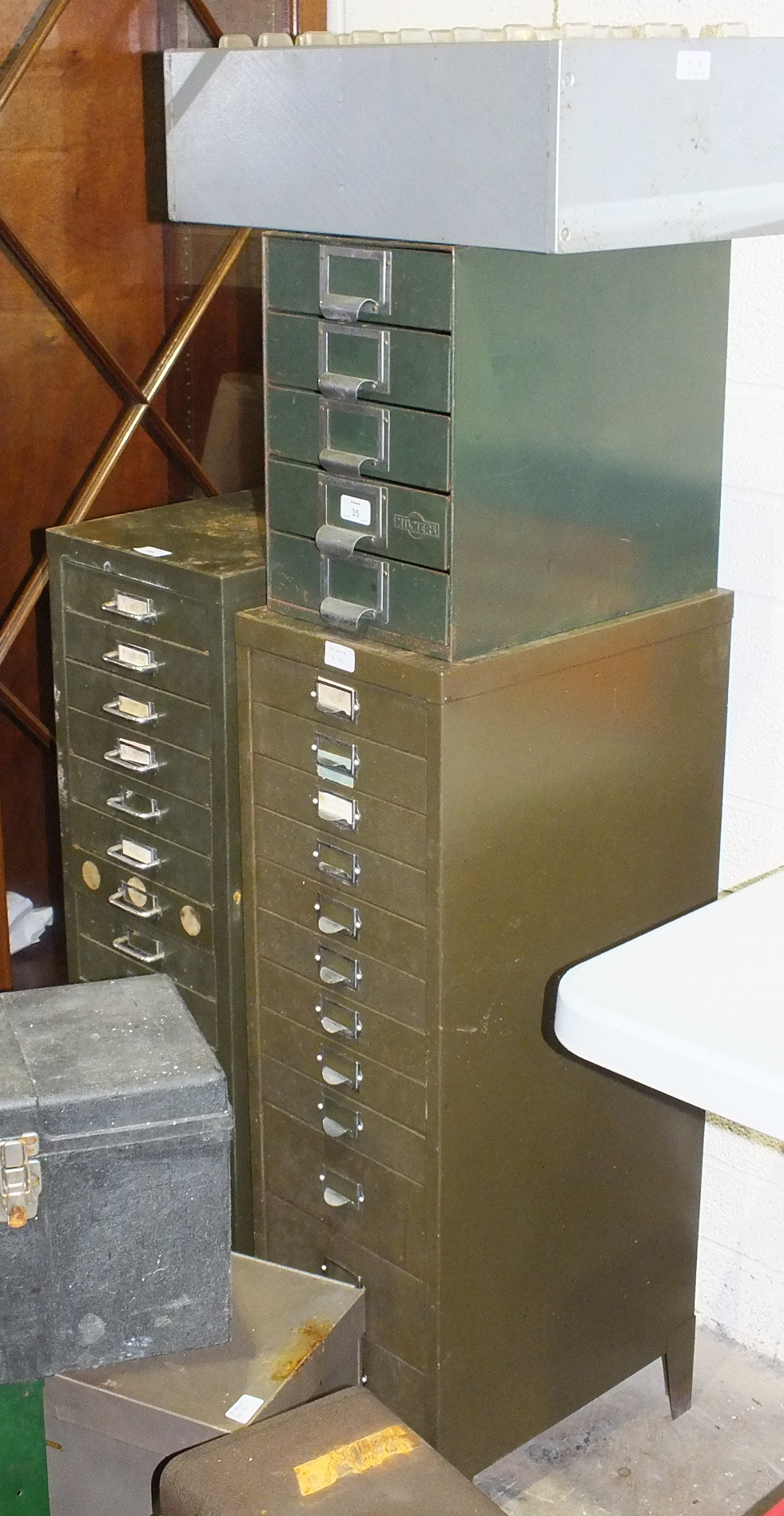 A metal fifteen-drawer chest, 28.5cm wide, 99cm high, another twelve-drawer chest and other metal