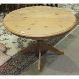 A modern pine extending circular table on column and quadruped base, 107cm diameter.