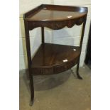 A 19th century mahogany bow-fronted two-tier corner wash stand, the lower tier with central drawer