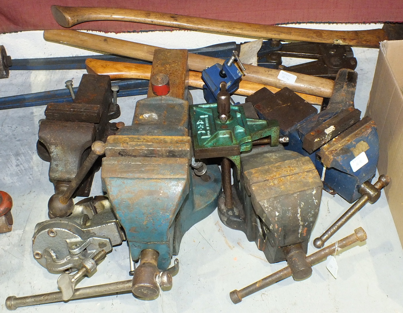 A collection of six various bench vices and other tools.