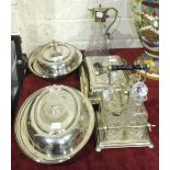 A four-bottle glass cruet on plated stand with turned wood handle, a glass claret jug with plated