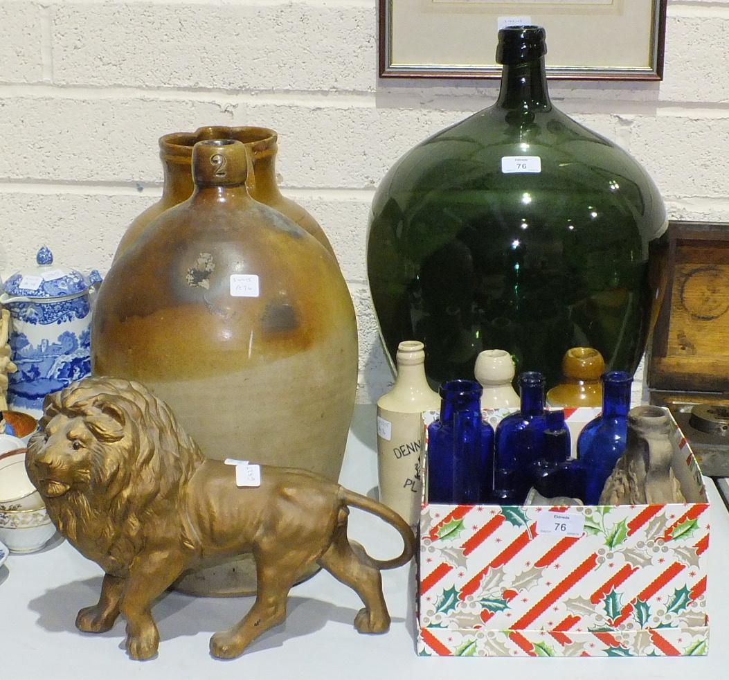 A green glass carboy, 47cm high, a small collection of blue glass medicine bottles, three