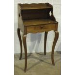 A late-19th/early-20th century lady's walnut writing table, the rectangular top fitted with a