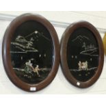 A pair of Oriental oval lacquered wall plaques with mother-of-pearl decoration, 53 x 41cm overall, a