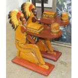 A pair of modern wooden smoker's stands in the form of a Red Indian kneeling, holding a tray, with