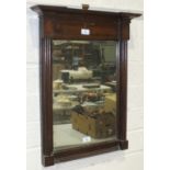 A 19th century mahogany-framed mirror of rectangular architectural form, 63 x 42.5cm.