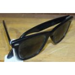 A pair of 1950's Ray-Ban Wayfarer black-framed sunglasses.