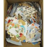 An all world accumulation of stamps loose on and off paper in three boxes.