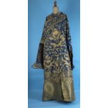 A Chinese robe of blue gauze embroidered overall in gold thread with dragons chasing flaming pearls,