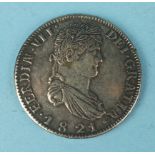 A Spanish 1821 eight Reales coin.