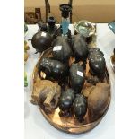 A small collection of ebony and other wooden elephants, three wooden biscuit barrels and a