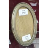 A silver oval photograph frame, Birmingham 1916, 16 x 11cm.