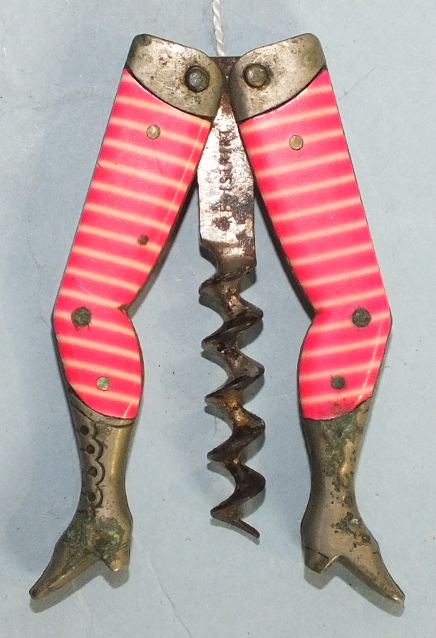 An early-20th century novelty corkscrew in the form of female legs decorated with pink striped