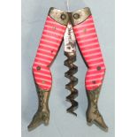 An early-20th century novelty corkscrew in the form of female legs decorated with pink striped