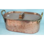 A Victorian copper fish kettle, the lid with strap handles, the base with two brass carrying