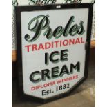 A painted hanging advertising sign for Prete's Traditional Ice Cream and other signs.