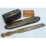 A steel-bladed Continental paper knife decorated with a city skyline and gilt ground, a gold