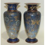 A pair of Doulton Lambeth stoneware vases decorated with enamelled and gilt flowers on a stippled