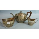 A three-piece oval tea service of half-gadrooned form, Sheffield 1902, ___21oz.