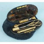 A 19th century French tortoiseshell sewing case of oval form containing scissors, thimble, bodkin